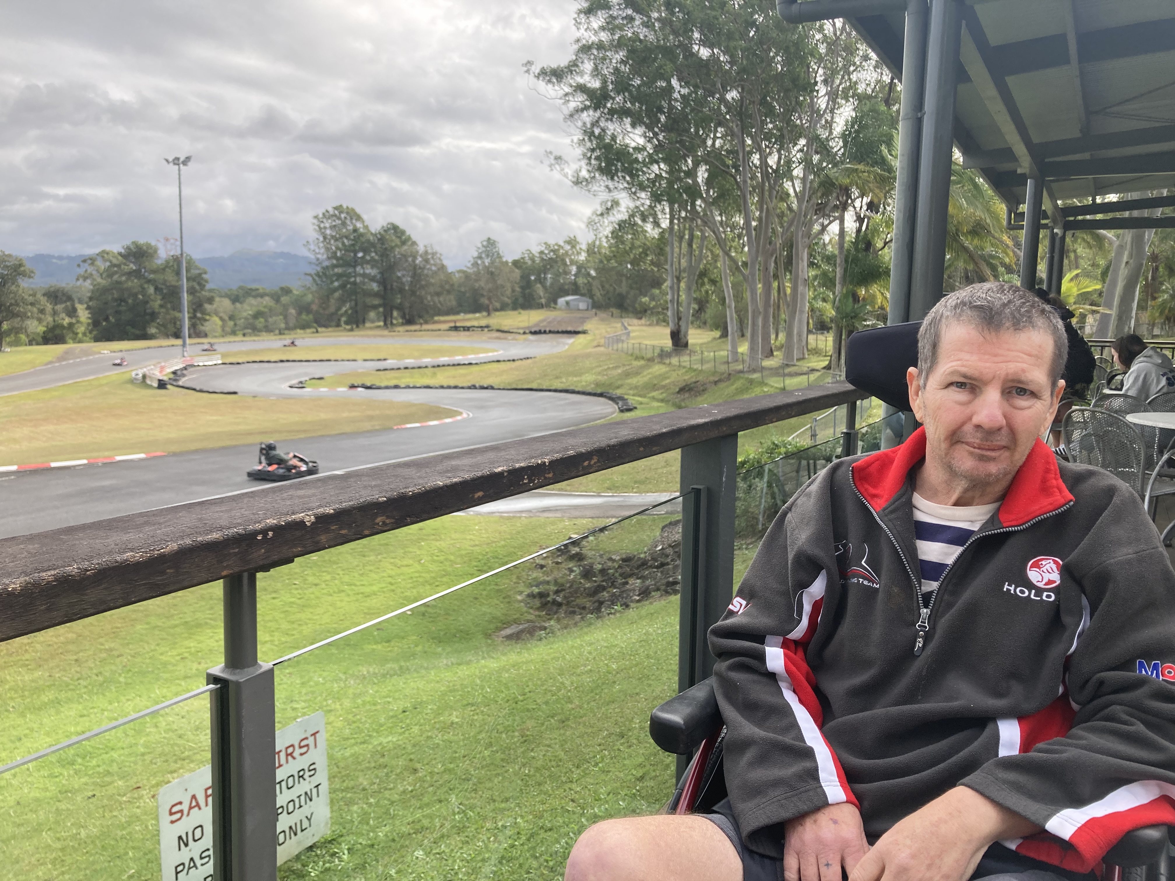 A participant watching the karts from the trackside shelter